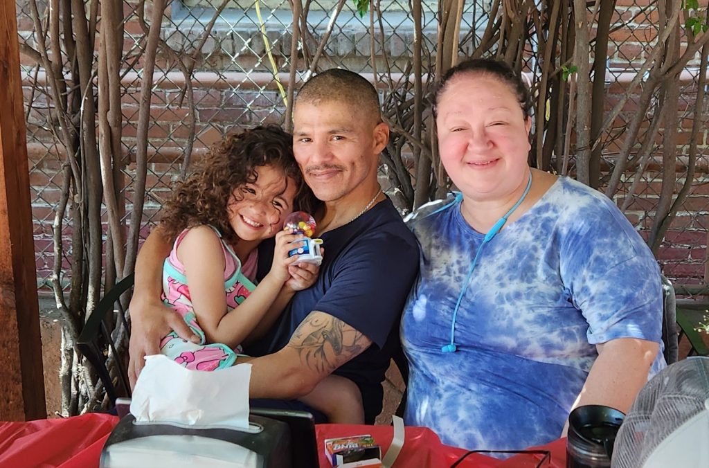 Three people at a Mother's Day visiting event for the Male Community Reentry Program, Los Angeles 2.