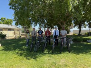 PVSP and Boys & Girls Club officials standing next to six bikes donated by PVSP bike shop