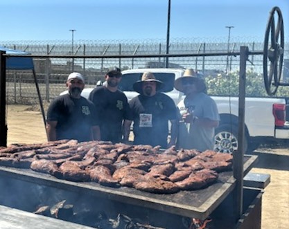 Staff from Pleasant Valley State Prison grill tri-tip for a fundraiser.