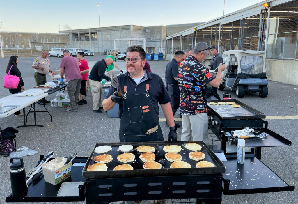 Working the griddle to make pancakes for a staff appreciation breakfast at CSP-Sacramento.
