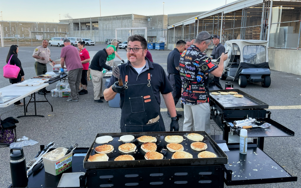 Working the griddle to make pancakes for a staff appreciation breakfast at CSP-Sacramento.
