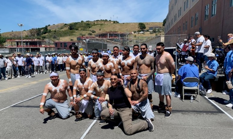 San Quentin incarcerated people who are also traditional dancers pose for a group photo for Cinco de Mayo.