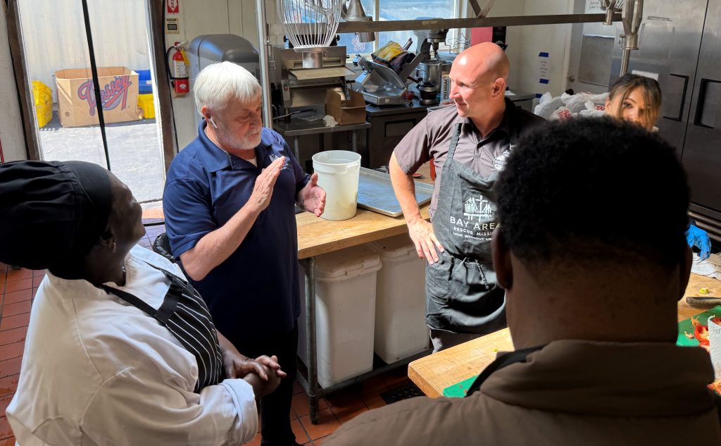 San Quentin Rehabilitation Center management tours the rescue mission where they met two formerly incarcerated people now employed at the mission.