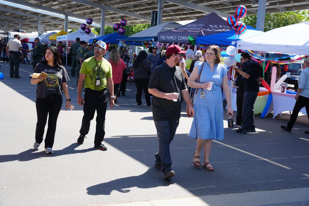 Employees stroll through the vendor area at the staff wellness fair at Valley State Prison in Chowchilla, California.
