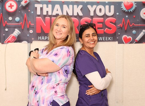 Two nurses, standing back-to-back, at Wasco State Prison-Reception Center in Delano.