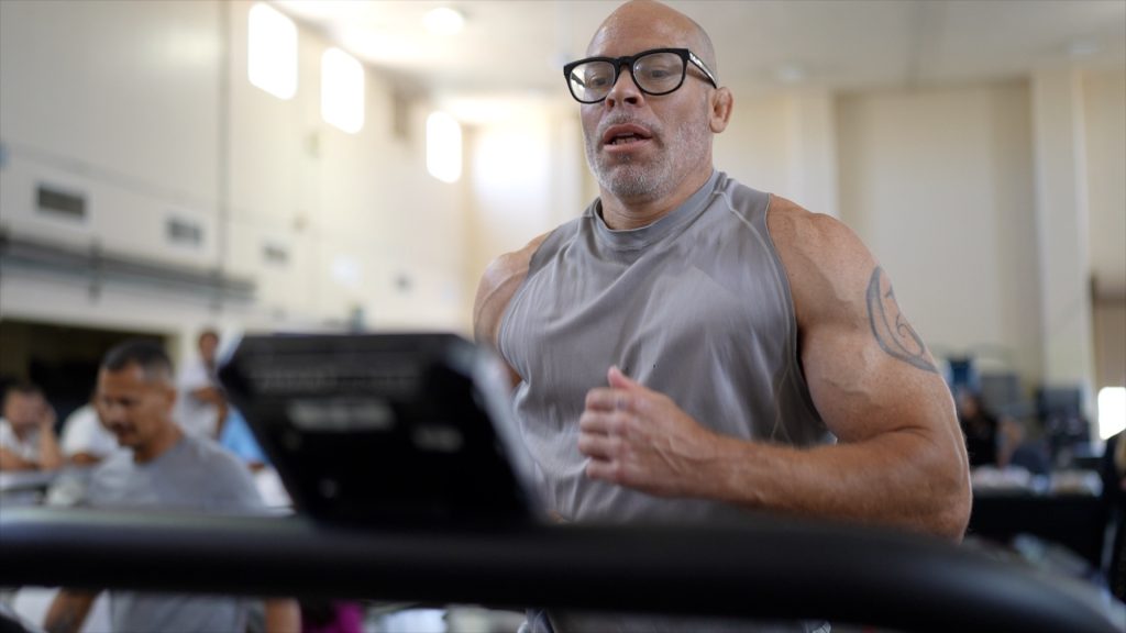 An incarcerated man runs on a treadmill at Avenal State Prison.