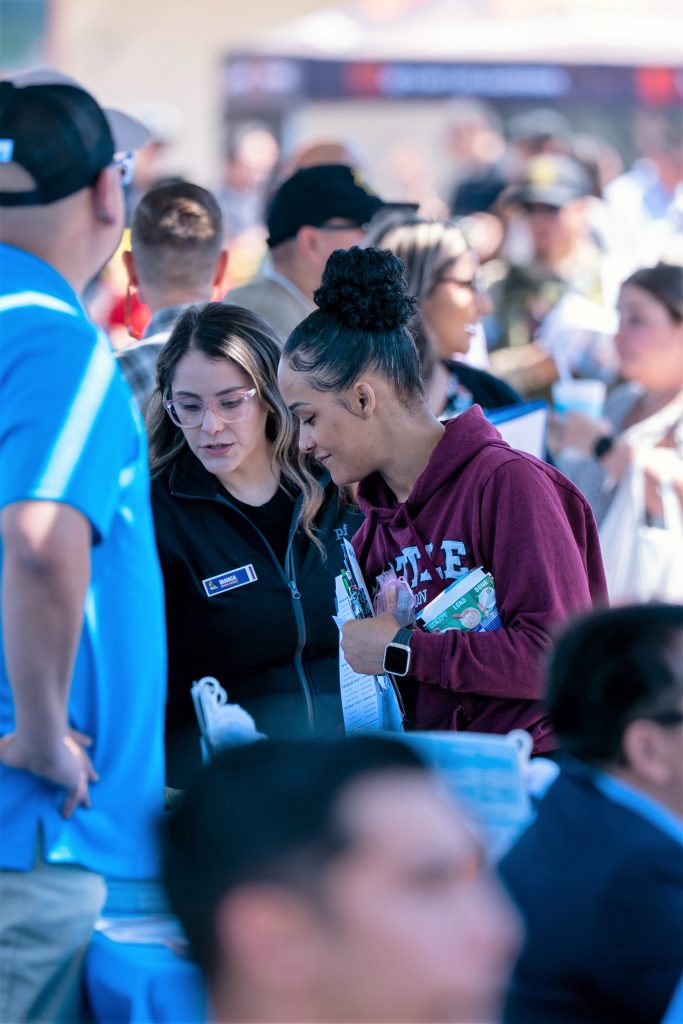 Staff health fair at CCWF with a group checking out a vendor booth.