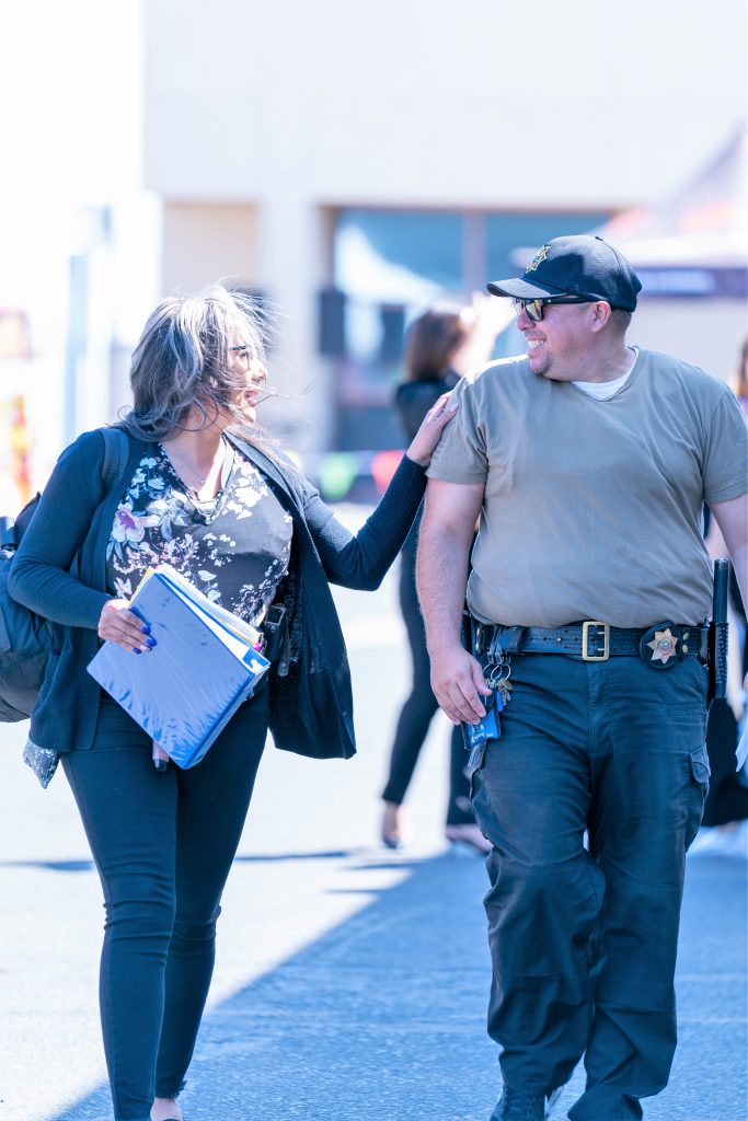 Smiling while two staff members walk at CCWF.
