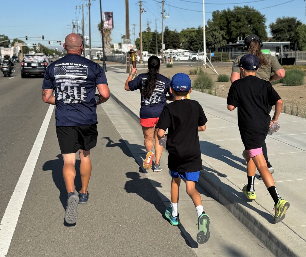 Runners carry the torch in Tracy.