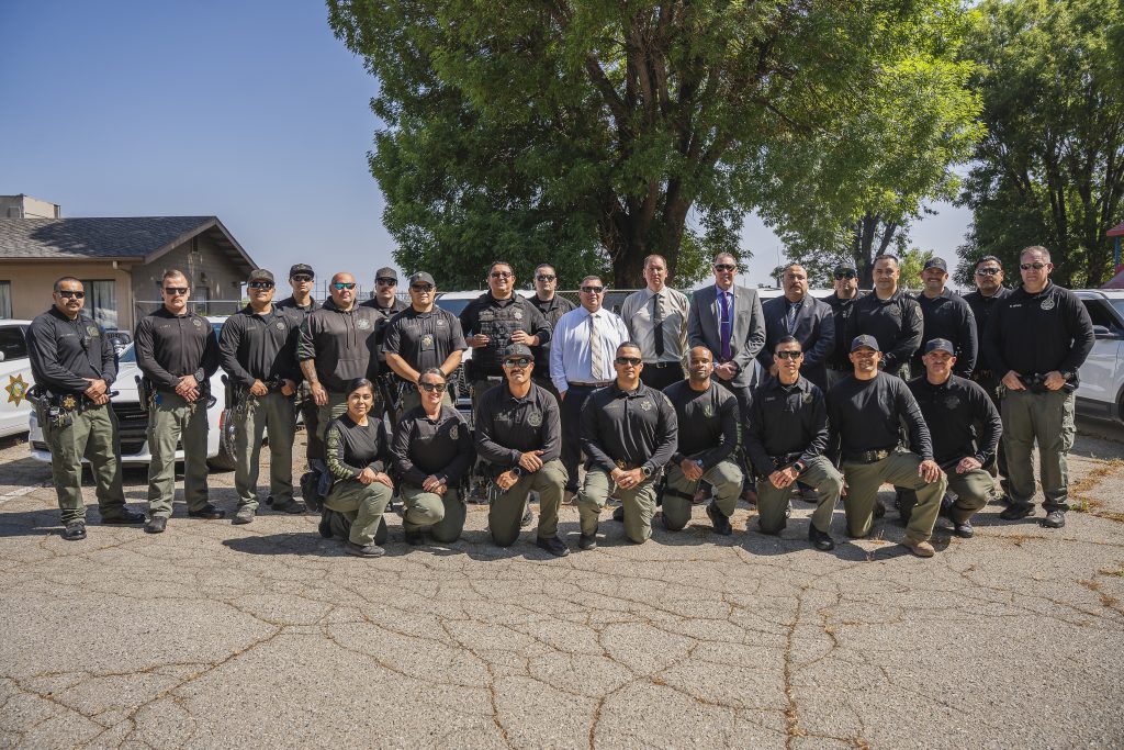 Group of officers, executives and K-9s at CIM.
