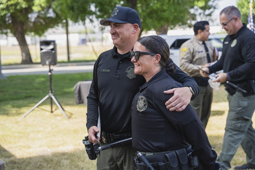 Quick hug at the ceremony for contraband-sniffing K-9s at CIM in Chino.