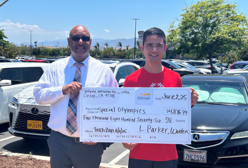 Warden Parker presented a check to Special Olympics from fundraising for the Law Enforcement Torch Run held June 2 in Chino.