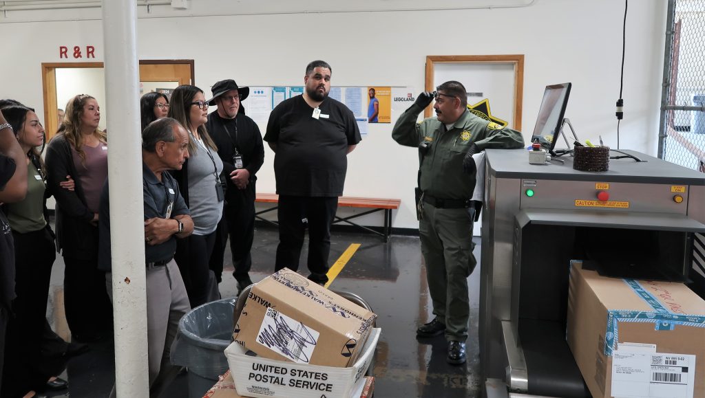 Demonstrating the scanner for mail coming into the Norco institution.