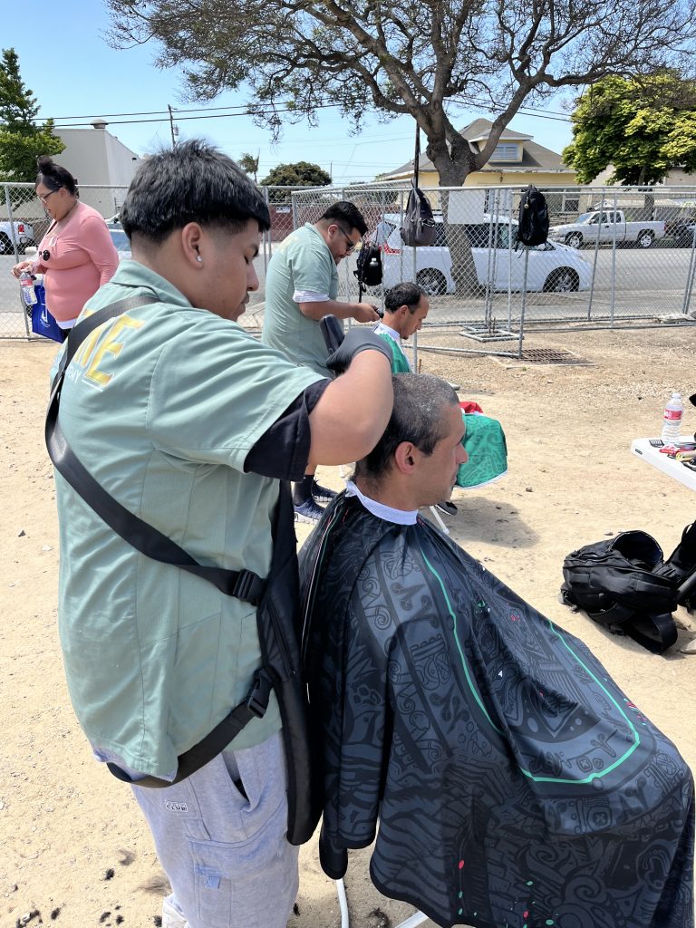 Supervised person receiving haircut