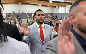 Mendoza raises his hand during the parole agent graduation ceremony held Friday, June 20, 2025, for Class 2-25P of the Basic Parole Agent Academy in Galt, California.