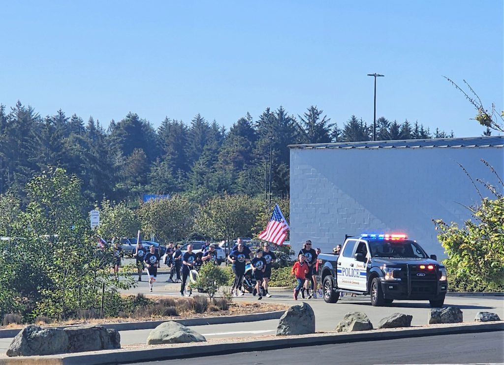 Pelican Bay CDCR runners approach the finish line in Cresent City during the Law Enforcement Torch Run 2025.