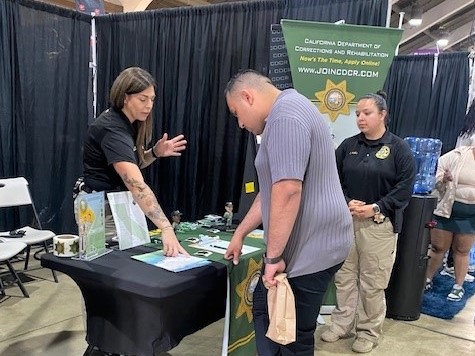 Answering questions about CDCR jobs at the booth at the Los Angeles County Fair.