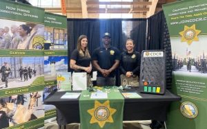 CDCR Peace Officer Recruitment team at Los Angeles County Fair in Pomona with three people at an information booth.