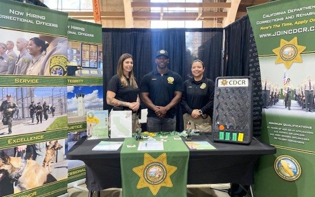 CDCR Peace Officer Recruitment team at Los Angeles County Fair in Pomona with three people at an information booth.