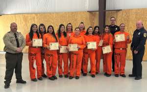 Group photo of incarcerated women graduating a firefighting program at Puerta La Cruz Conservation Camp 14.