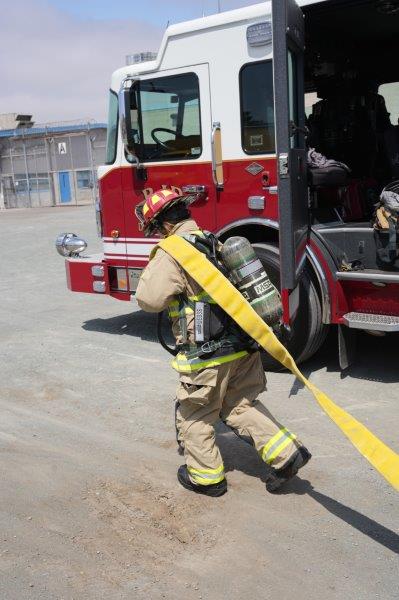 RJD staff appreciation with a person pulling a firehose. 