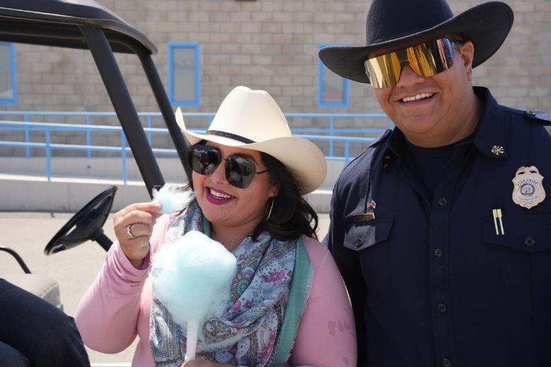 staff adorning cowboy hats and eating cotton candy