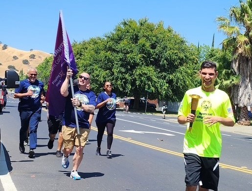 CSP-Solano with a Special Olympics athlete carrying the Flame of Hope torch.