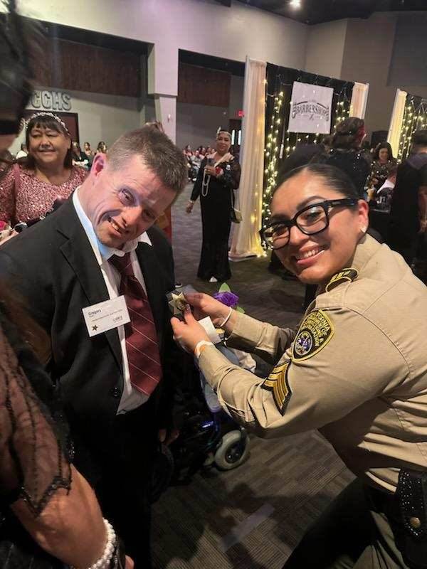 ciw staff placing boutonniere on prom attendee