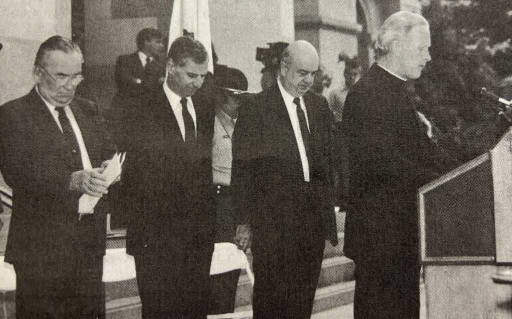Department director, governor, secretary and chaplain observe a moment of silence.