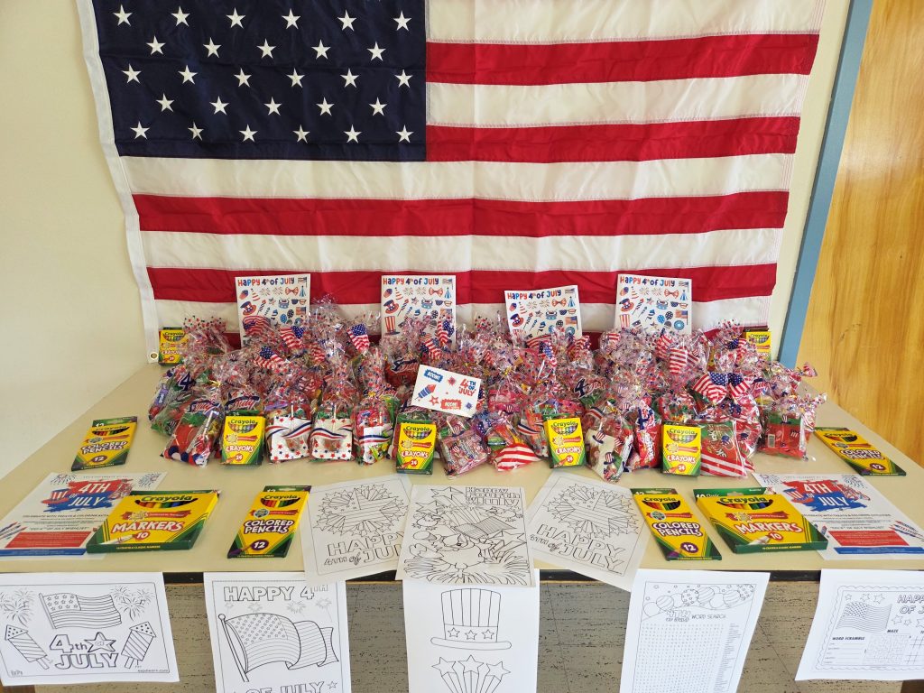 Activity table with crayons and coloring sheets as well as a goody bag. 