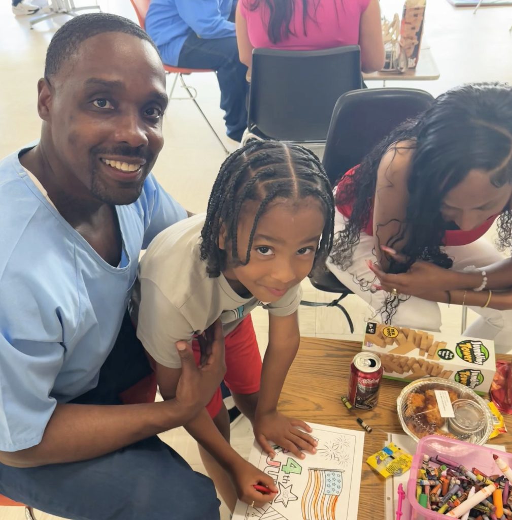 A family enjoys crafts at CCI for visiting during Fourth of July weekend.