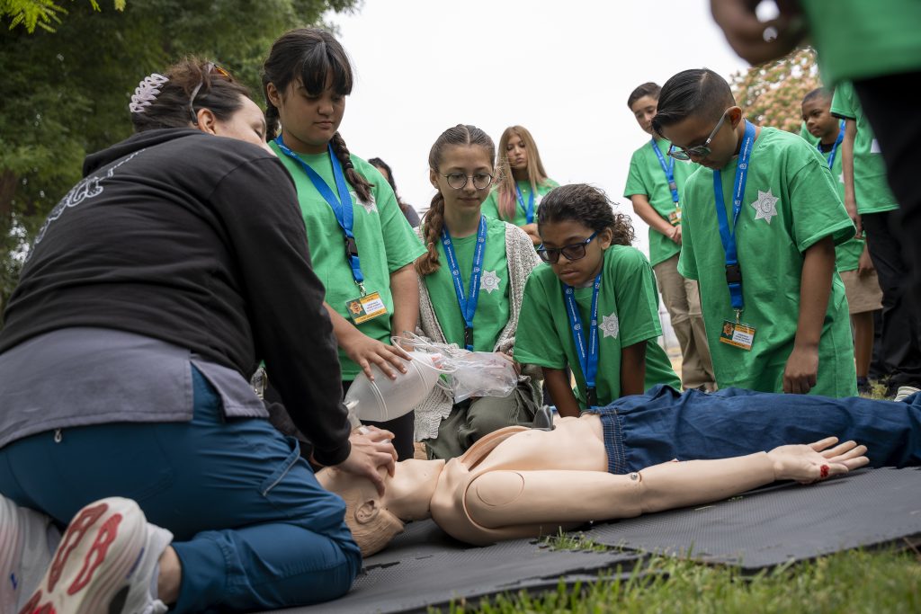 Children learn CPR.