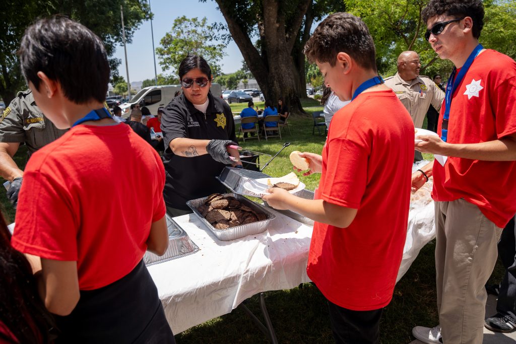 Staff serve lunch to children at CIM.