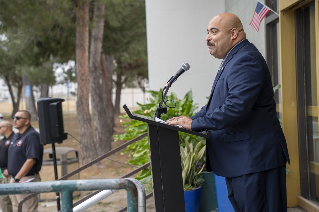 Eric Mejia, acting warden at CIM, speaks to the crowd for the Junior Academy.