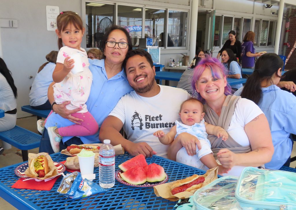 A family enjoys the patriotic themed Fourth of July visiting at CIW in Cororna.