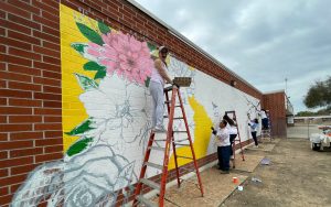 Incarcerated people paint a mural at CIW.
