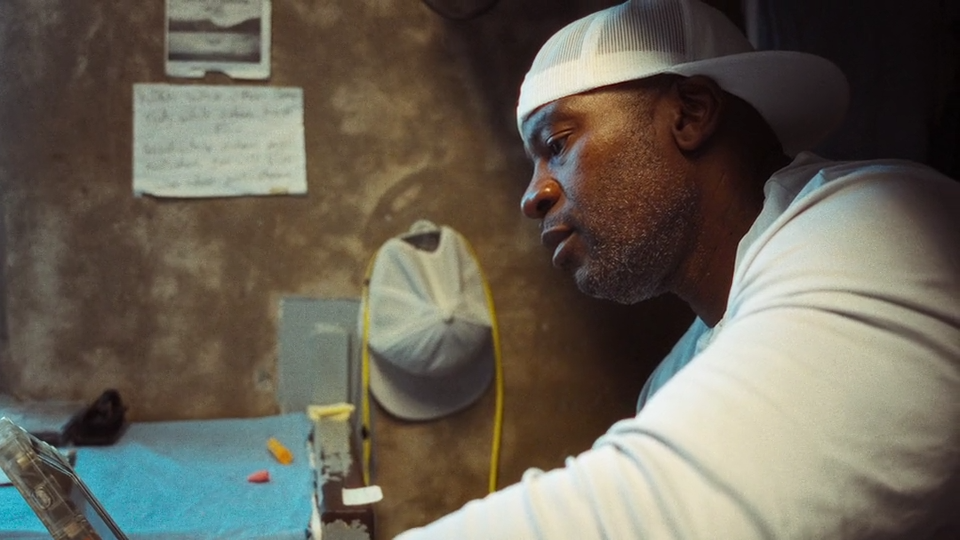 Crayon reading a book in his cell at North Kern State Prison.