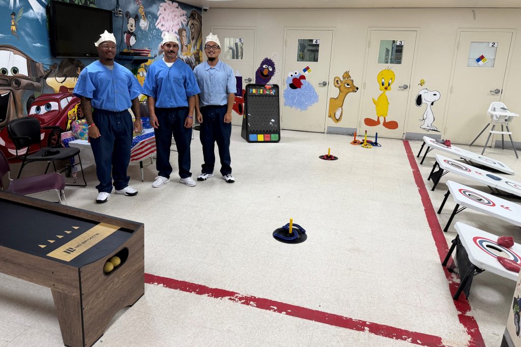 Three incarcerated people volunteer to run the game station at Folsom State Prison. 