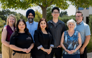 Nurse Consultant Punardeep Dhillon, who helped save a woman mid-flight, poses for a group photo with the rest of the team at CCHCS headquarters in Elk Grove, California.