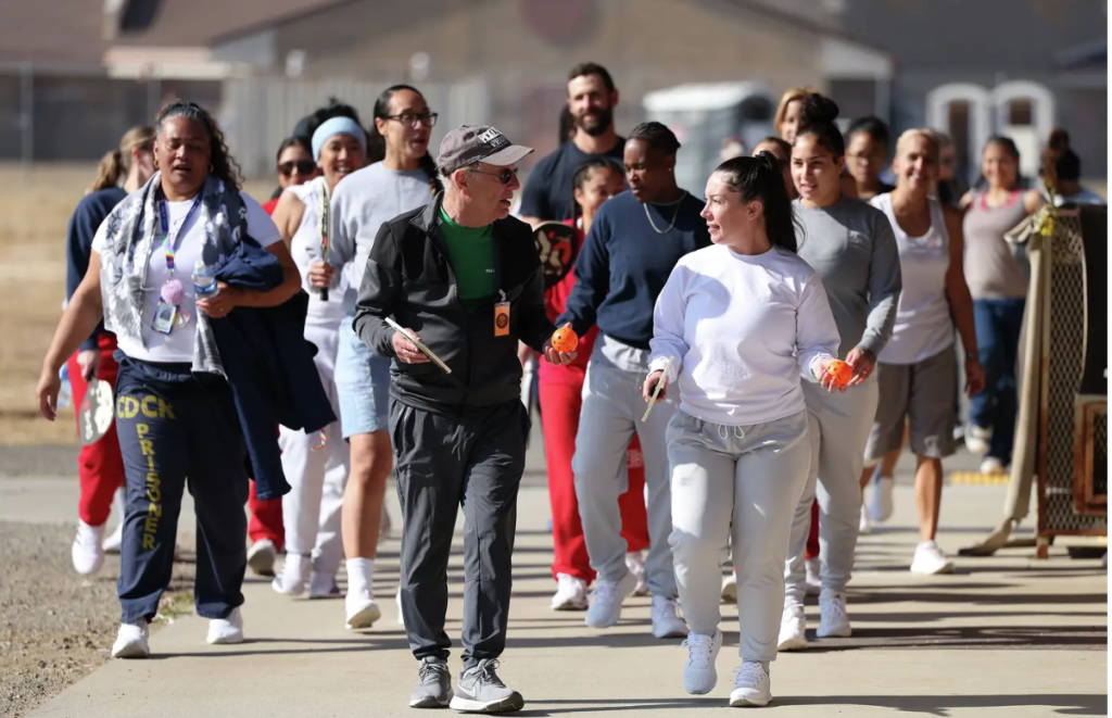 Roger BelAir with incarcerated women he coached, as well as a couple of staff members, at the Central California Women’s Facility in November 2024. Simaima Ohuafi is in the far left.