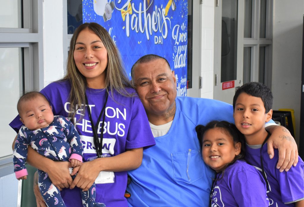 A family hugs at Salinas Valley State Prison in Soledad, Calif., Aug. 2.