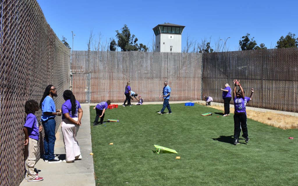 Families play a game on the grass at Salinas Valley State Prison in Soledad, California.