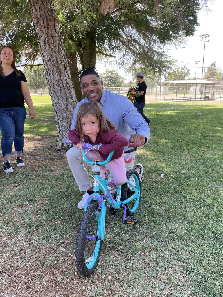 Event goers with a bike, smiling