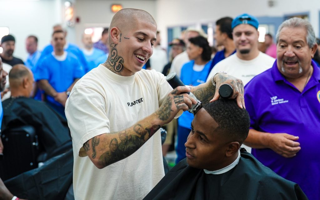 VicBlends, a social media influencer and barber, cuts hair at the new barbering school at Valley State Prison (VSP) in Chowchilla.