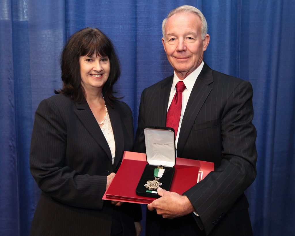 A woman awarded the distinguished service medal.