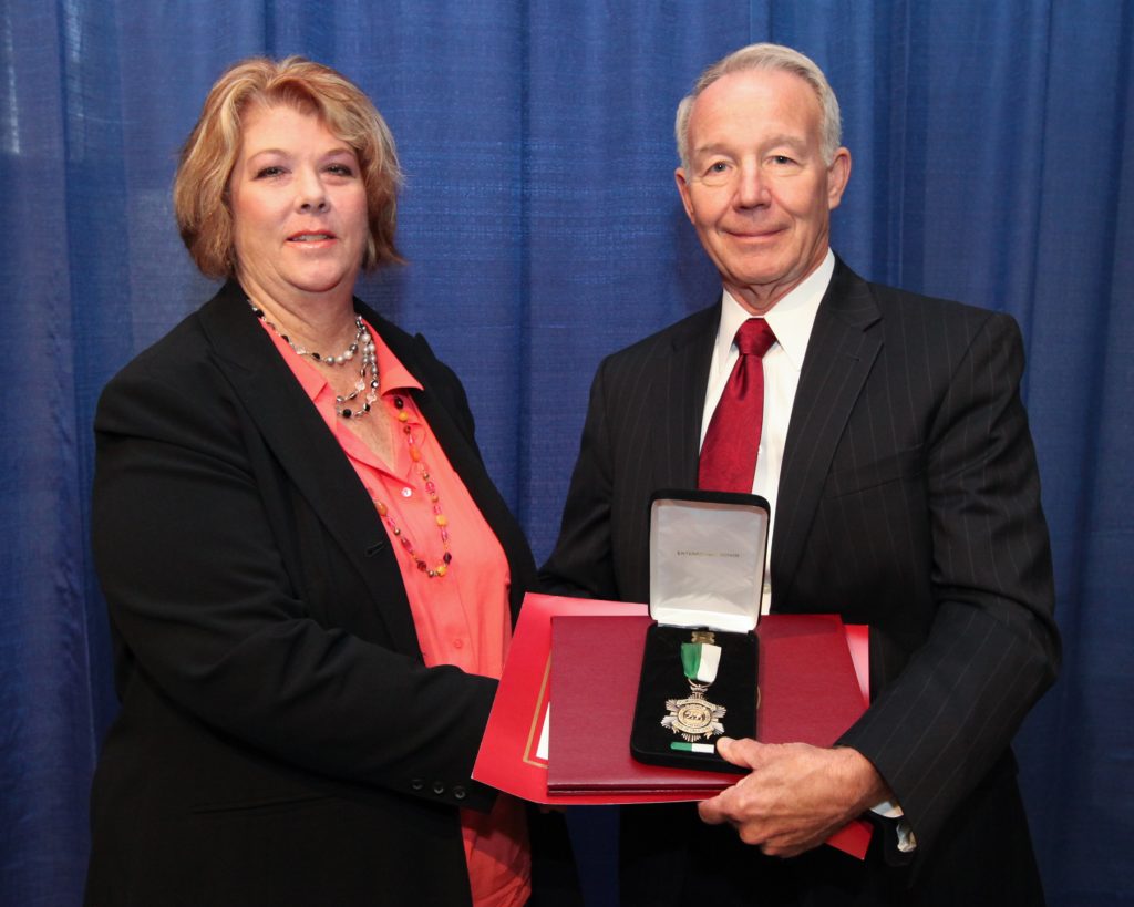 Two people and a distinguished service medal.