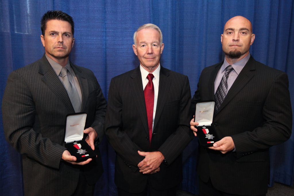 Two people receive silver star medals at Medal of Valor ceremony in 2013.