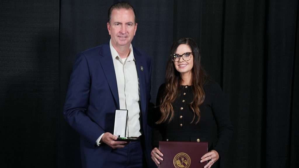 Distinguish Service medal to Dr. Morgan Elias with Secretary Macomber.