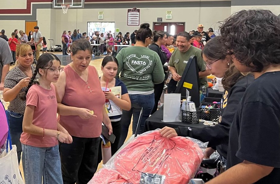 Children receiving school supplies donated by Avenal State Prison and the community.