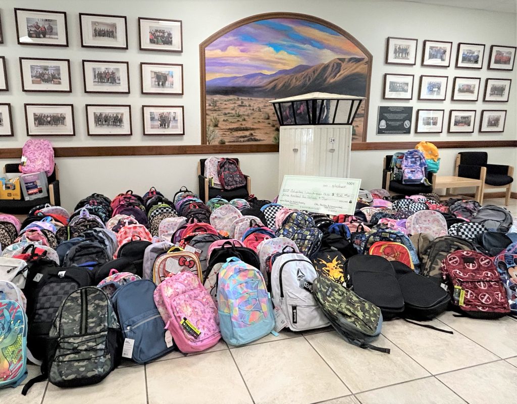 Backpacks and a check for the back-to-school drive at Calipatria State Prison.